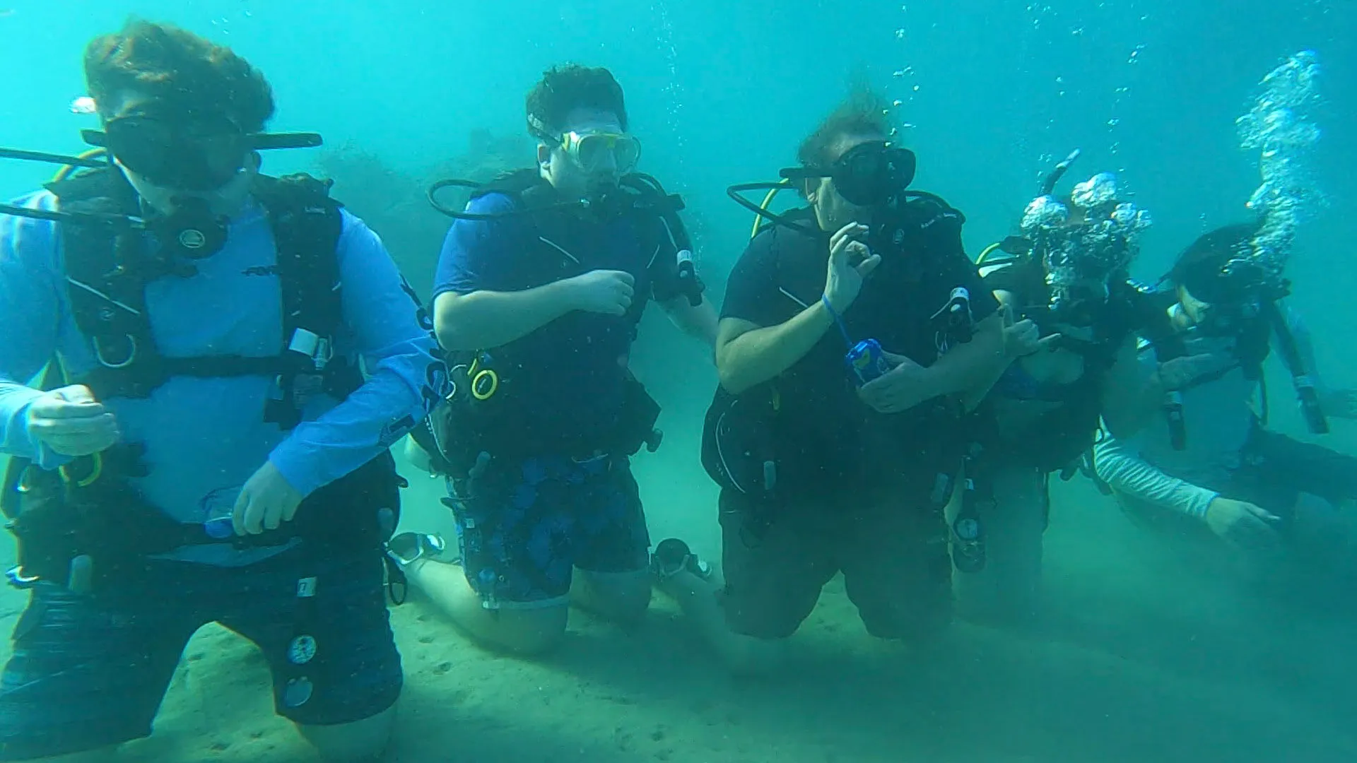 a group of people standing around a motorcycle