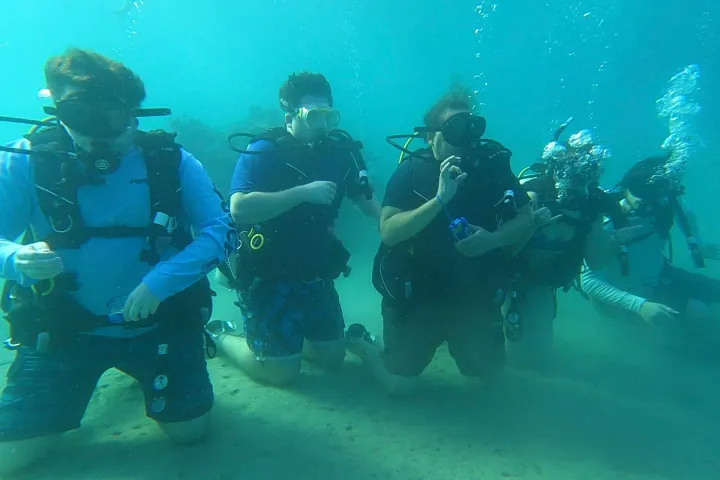 a group of people standing around a motorcycle
